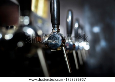 taps for beer production metal Royalty-Free Stock Photo #1939896937