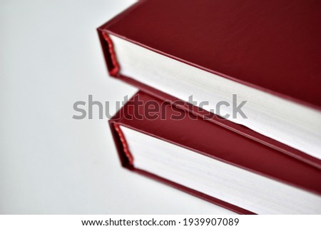 Red bound books on a white background