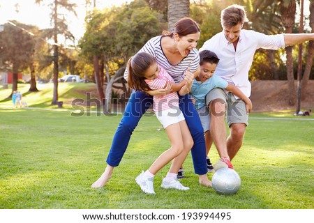 Family Playing Soccer In Park Together Royalty-Free Stock Photo #193994495
