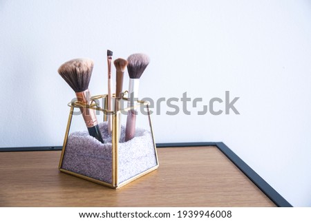 transparent organizer for makeup brushes. Indoor modern design decor. Make up tools Royalty-Free Stock Photo #1939946008