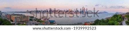 New York, New York, USA Midtown Manhattan skyline on the Hudson River at night.