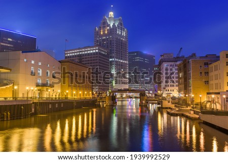 Milwaukee, Wisconsin, USA downtown skyline on the Milwaukee River in the evening.