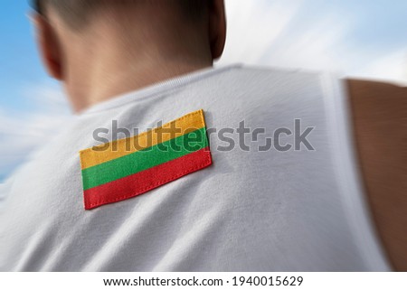 The national flag of Lithuania on the athlete's back