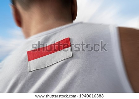 The national flag of Indonesia on the athlete's back
