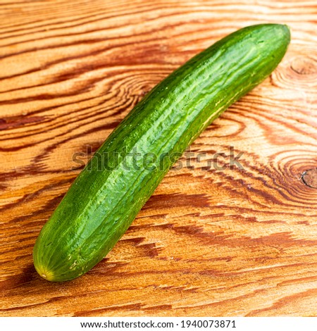 green cucumber on the wooden surface of the table. High quality photo
