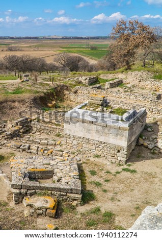 Vertical view of ancient ruins and a well in the landmark site of the ancient city of Troy near Canakkale, Turkey