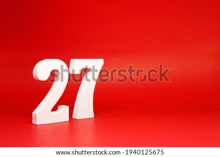 Twenty Seven ( 27 ) white number wooden Isolated Red Background with Copy Space - New promotion 27% Percentage  Business finance Concept 