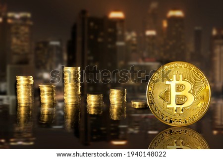 Bitcoin and stack coins of baht on the night city background.  Finance and investment concept.