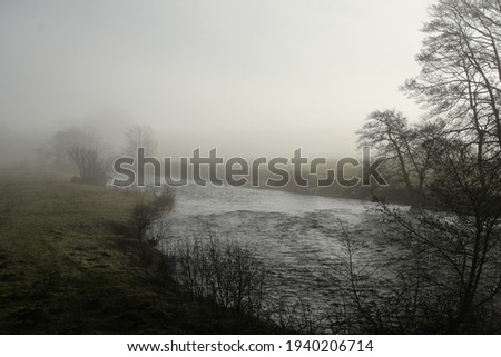 View looking across the banks of the River Doon on a misty morning in March.