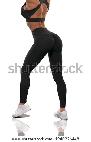 legs girl in black leggings and a top stay back on a white background