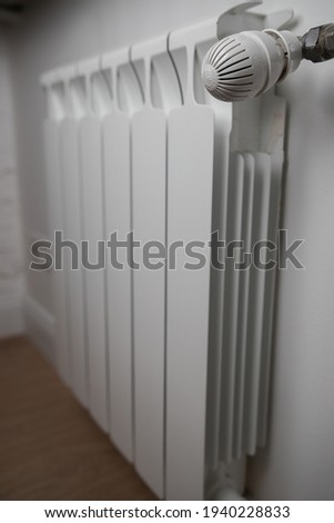 Panel heating with heat regulator. White radiator