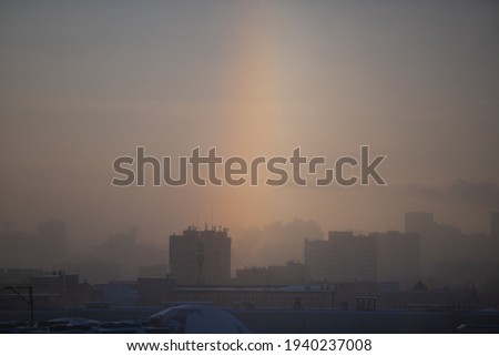 City landscape against the background of the winter sun with a halo. Uglich, Russia