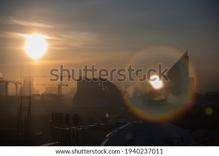 City landscape against the background of the winter sun with a halo. Uglich, Russia