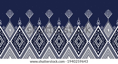 White on dark blue background.Geometric ethnic oriental ikat pattern traditional Design.Geometric ethnic oriental pattern traditional Design for background,carpet,clothing,fabric,embroidery style