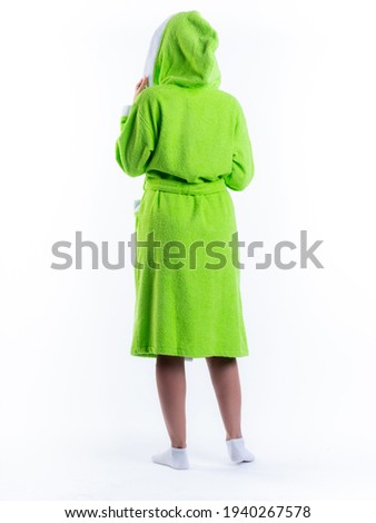 woman in a dressing gown from the back on an isolated white background. Shot in the Studio in full growth.