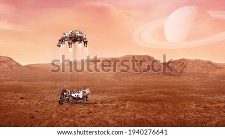 Landing of  Mars Rover on surface of red planet. Elements of this image furnished by NASA. Royalty-Free Stock Photo #1940276641