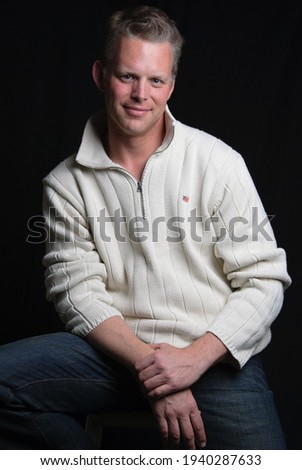 Portrait handsome young guy. Photo wit filter, black background Man wearing modern white winter casual shirt -Clipping path included, white black face collar hand sitting attractive indoor chair 