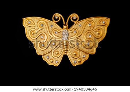 Vintage gold butterfly belt buckle from the 80s with rhinestone inlaid on it