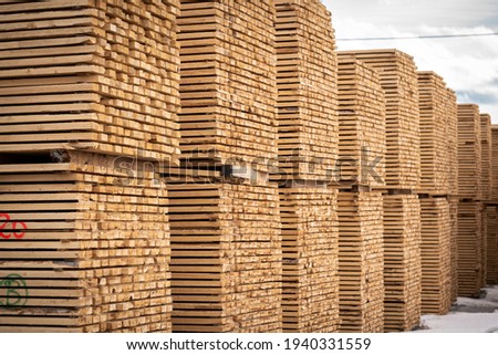 Rough 2x4 spruce and pine SPF lumber piled at a sawmill Royalty-Free Stock Photo #1940331559