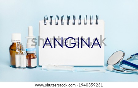 On a light background, a syringe, a stethoscope, vials of medicine, an ampoule and a white notepad with the text ANGINA. Medical concept