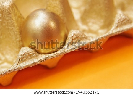 Golden chicken egg on a special egg holder