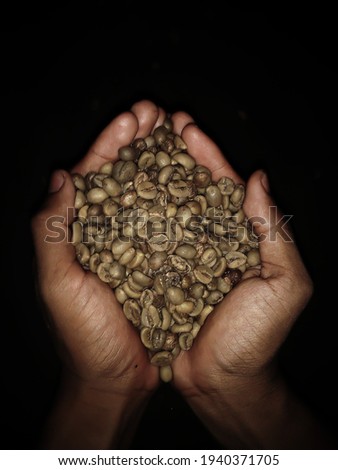 handful of coffee beans on black background