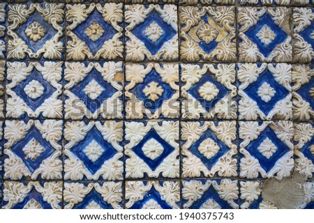 Used blue tiles on the exterior wall of a traditional house in the city of Lisbon in Portugal. 