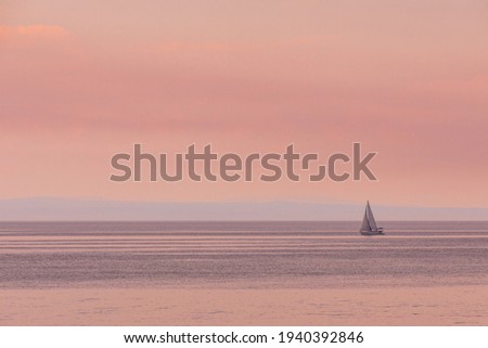 one little sail yacht on sunset at sea bay copy space