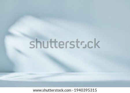 Abstract blue background with drop shadow and light. Backdrop for product presentation Royalty-Free Stock Photo #1940395315