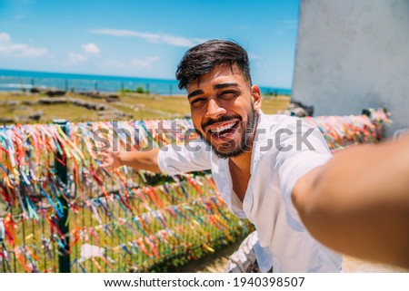 Friendly young Latin American man inviting to come to Brazil, confident and smiling making a gesture with his hand, being positive and friendly Royalty-Free Stock Photo #1940398507