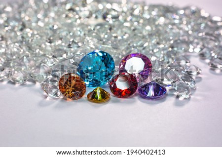 colorful diamonds are placed on a pile of white diamonds And keep turning. video 4k resolution shoot in studio
