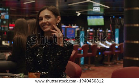 Portrait of a joyful girl who won the casino. Gambling, nightlife