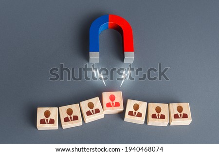 Magnet is trying to snatch a key irreplaceable employee from the team. Violation of the integrity of the team. Loss of morale. Intervention in the internal affairs. Find spy intruder. Luring Royalty-Free Stock Photo #1940468074