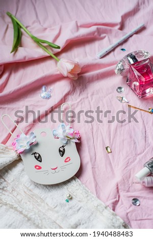 Happy Easter Greeting card. Flower, glitter, parfume and a white bunny ears on pink background. Concept of holiday, birthday, March 8. Flat lay. Cute small feminine stuff, top view. Girly Things.