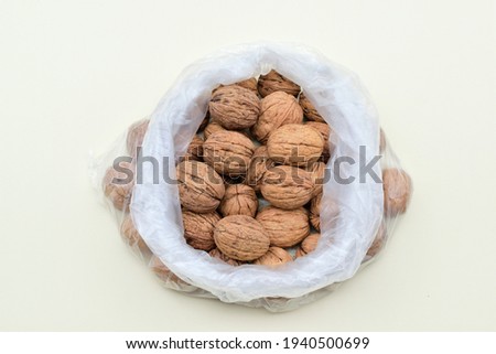 Walnuts in a plastic bag isolated on white background