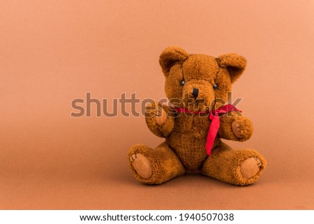 Teddy bear toy on a brown background with copy space. Toy.