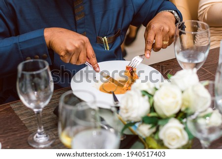 Married Man eating a continental cuisine with fork and knife