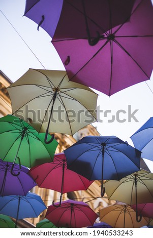 Colorful umbrellas hang against the blue sky. High quality photo