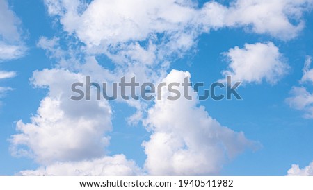 Fluffy clouds on blue sky, beautiful cloudy sky with white puffy clouds. Sky background.