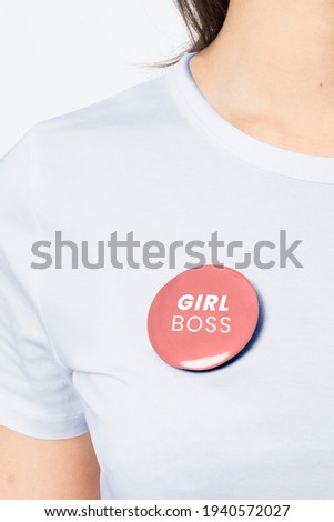 Girl Boss badge pin on a woman's t-shirt close up Royalty-Free Stock Photo #1940572027
