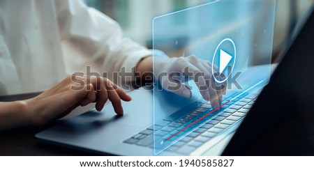 Hand using laptop and press screen to video streaming on internet online. Concept communication network.  Royalty-Free Stock Photo #1940585827