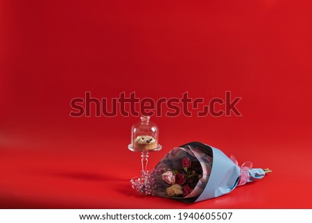 cake and dry multicolored flowers tulips on red background