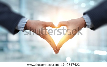 Female hands form heart shape