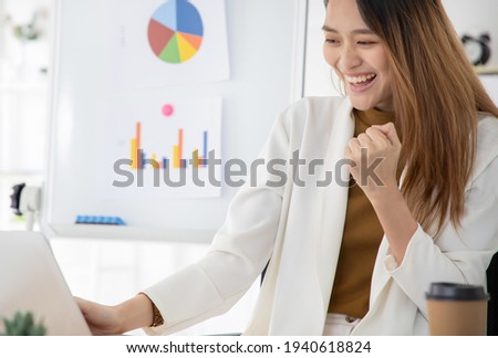 Beautiful Asian woman celebrate with laptop, success happy pose. E-commerce, or startup small business concept.
