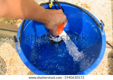 Testing bilge pump connected to use power from solar cell panel  Royalty-Free Stock Photo #1940630572