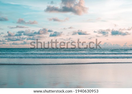 Sea wave and beach sand with refection of sky on sunset time. Nobody nature calm and relax background Royalty-Free Stock Photo #1940630953