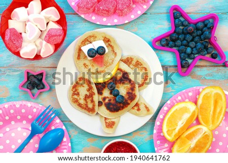 Fun food for kids. Bird shaped pancakes on blue wooden table. Healthy eating. Creative idea for children breakfast