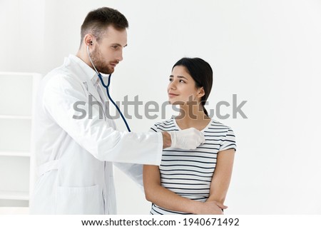 doctor in a white coat stethoscope examination of a patient hospital