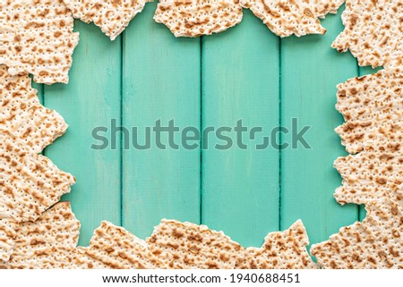 Matzah for Jewish holiday Pesach laid out in the frame. Free space for text.
