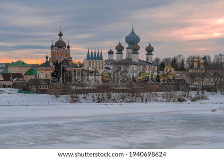 View of the Tikhvin Assumption Monastery on a cloudy March evening. Leningrad region, Russia Royalty-Free Stock Photo #1940698624